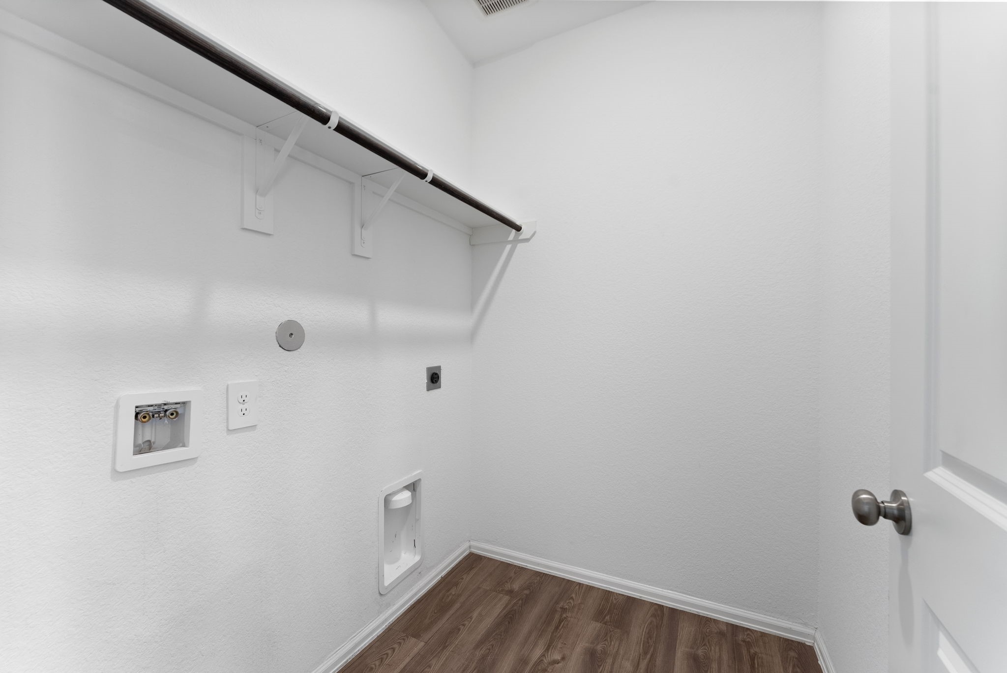 2850 Paradise Ridge Way Conroe, TX 77301 - Photo 13 of 21 Dedicated laundry room including a shelf and rod for storage or hanging clothes.