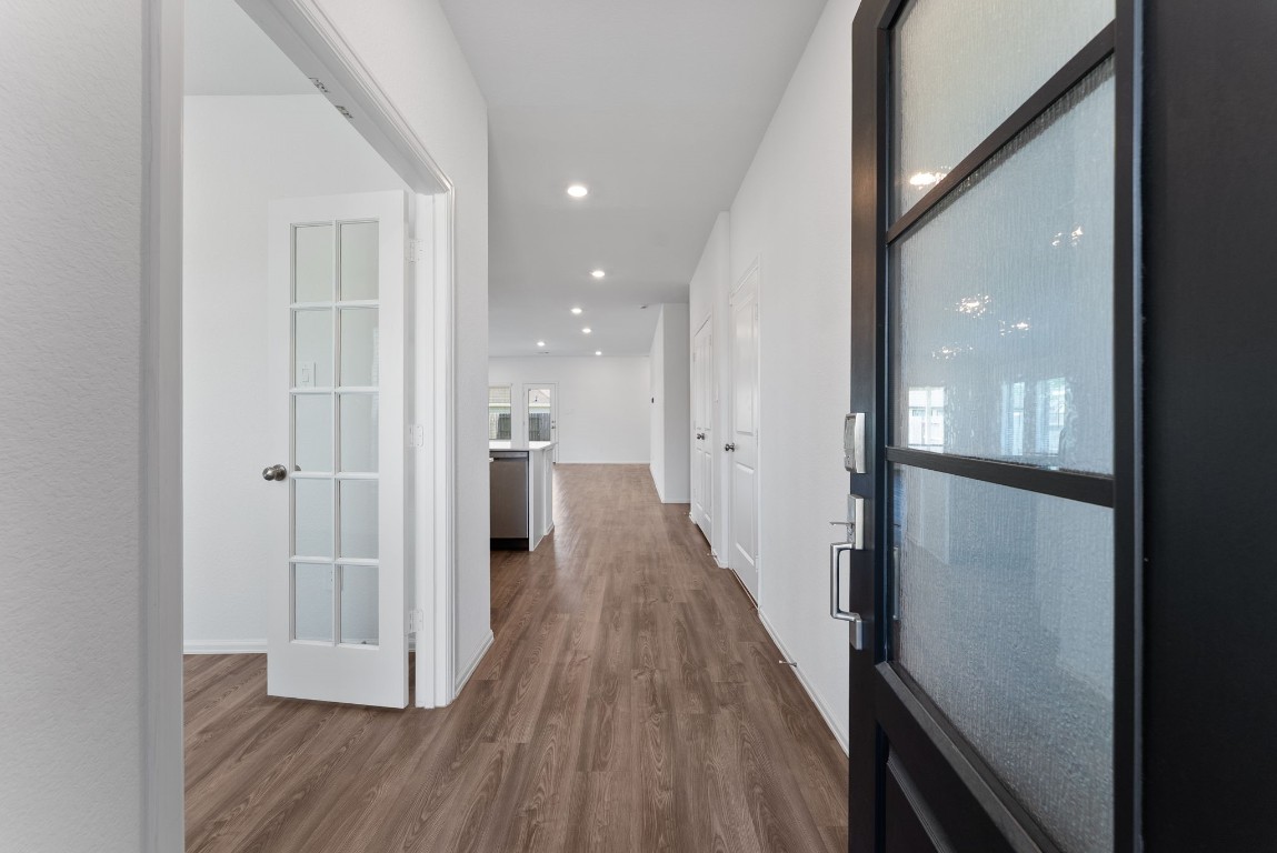 2850 Paradise Ridge Way Conroe, TX 77301 - Photo 3 of 22 a view of a hallway with wooden floor
