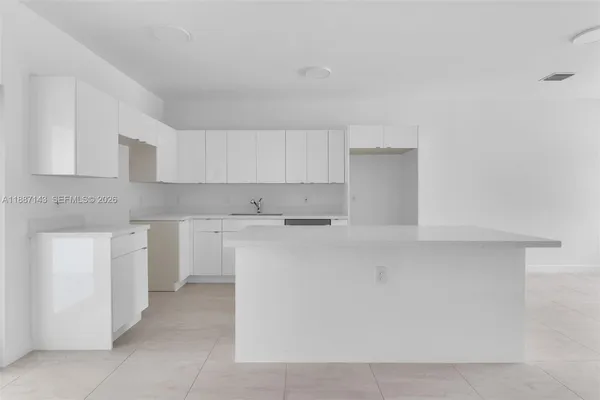 a kitchen with cabinets and a stove top oven