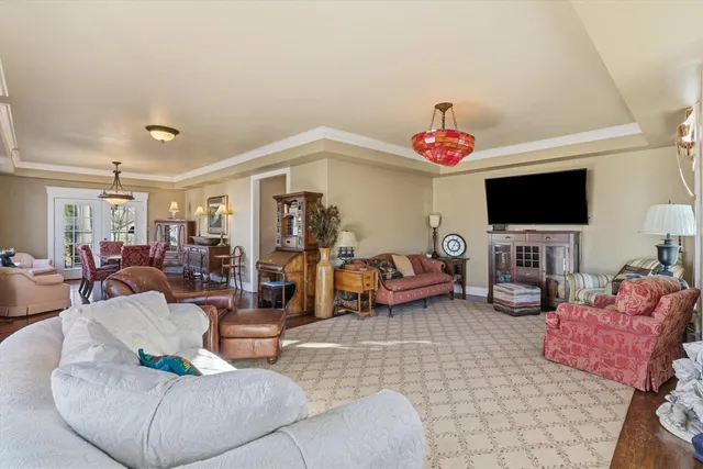a living room with furniture a flat screen tv and a window