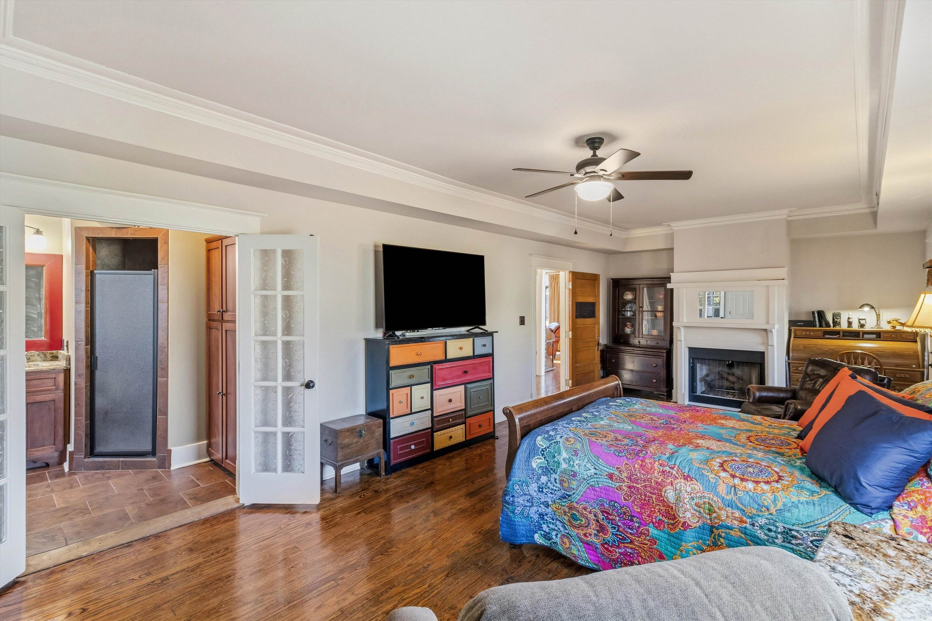 30 Front Street Rossville, TN 38066 - Photo 14 of 39 Bedroom featuring wood finished floors, ornamental molding, a gas fireplace, ceiling fan, and ensuite bathroom.