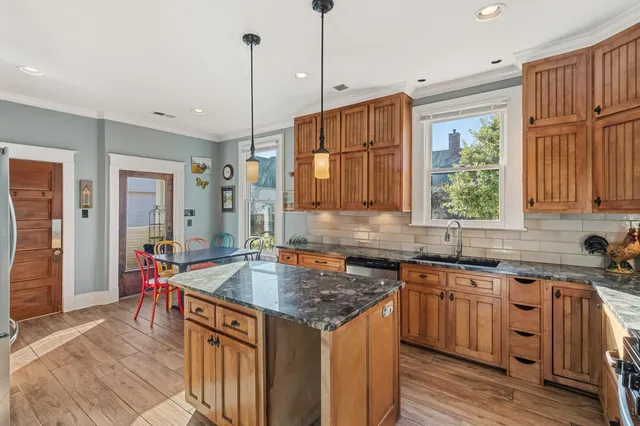 a kitchen with stainless steel appliances granite countertop a sink stove and refrigerator