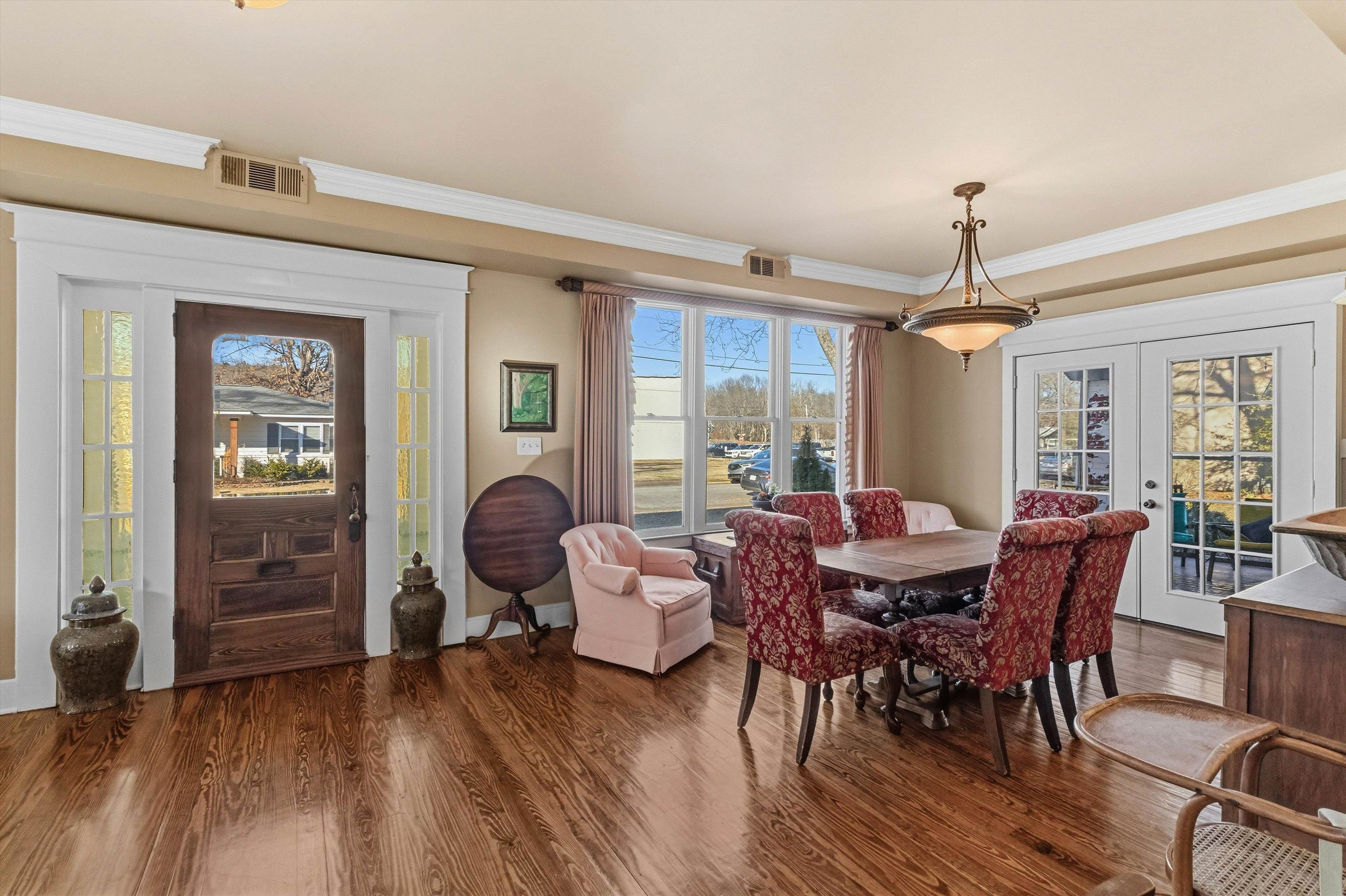 30 Front Street Rossville, TN 38066 - Photo 26 of 39 Dining space with dark wood-style floors, plenty of natural light, and crown molding. French doors lead to the screened-in porch,