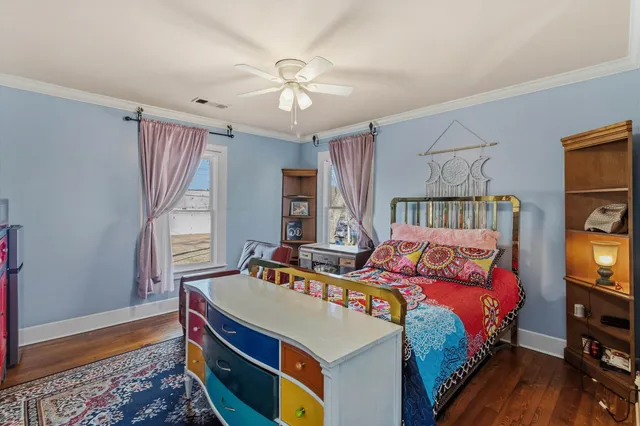 a bedroom with a bed and a tv on table