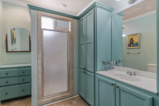 a bathroom with a mirror sink and glass door