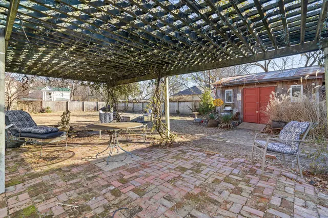 a view of patio with table and chairs and potted plants