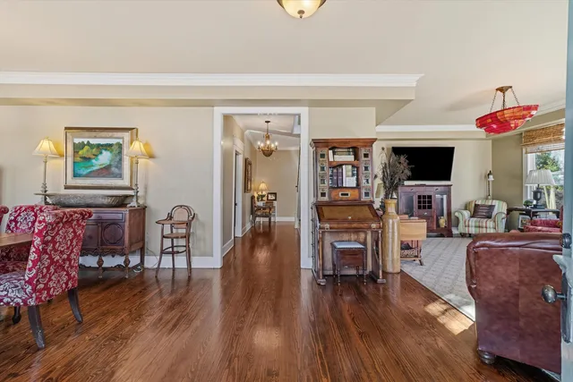 a living room with fireplace furniture and a wooden floor