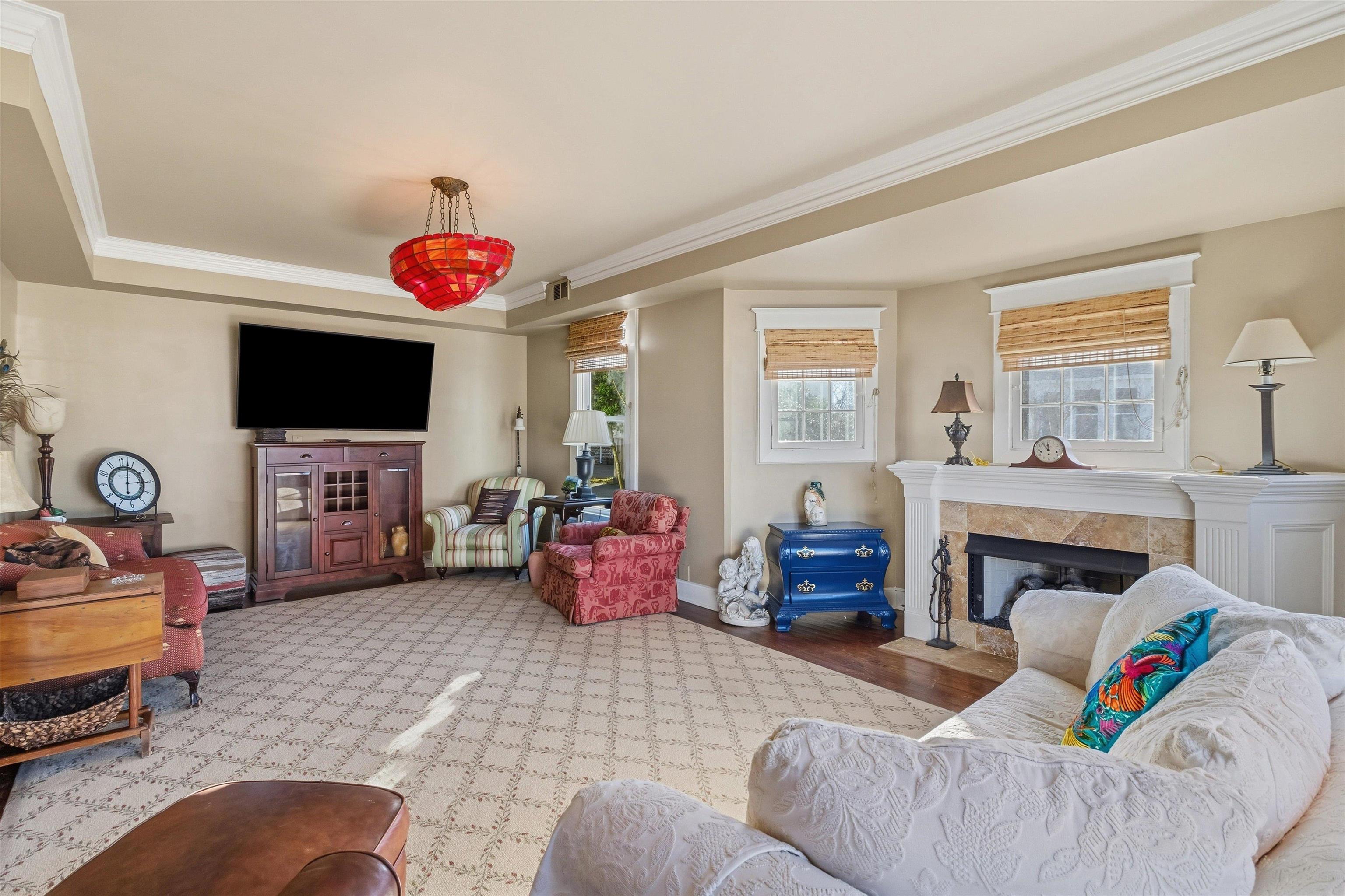 30 Front Street Rossville, TN 38066 - Photo 5 of 39 Living area with ornamental molding, a gas fireplace, a tray ceiling, and wood finished floors
