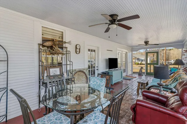 a living room with furniture a fireplace and a chandelier