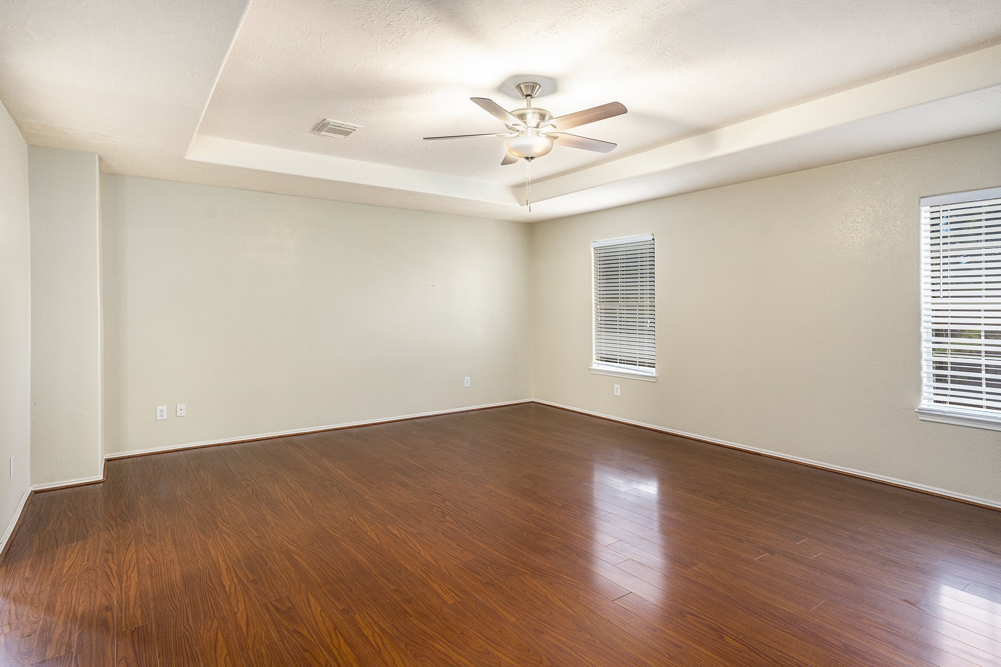 18227 Thicket Grove Road Houston, TX 77084 - Photo 12 of 28 a view of an empty room with wooden floor and a window