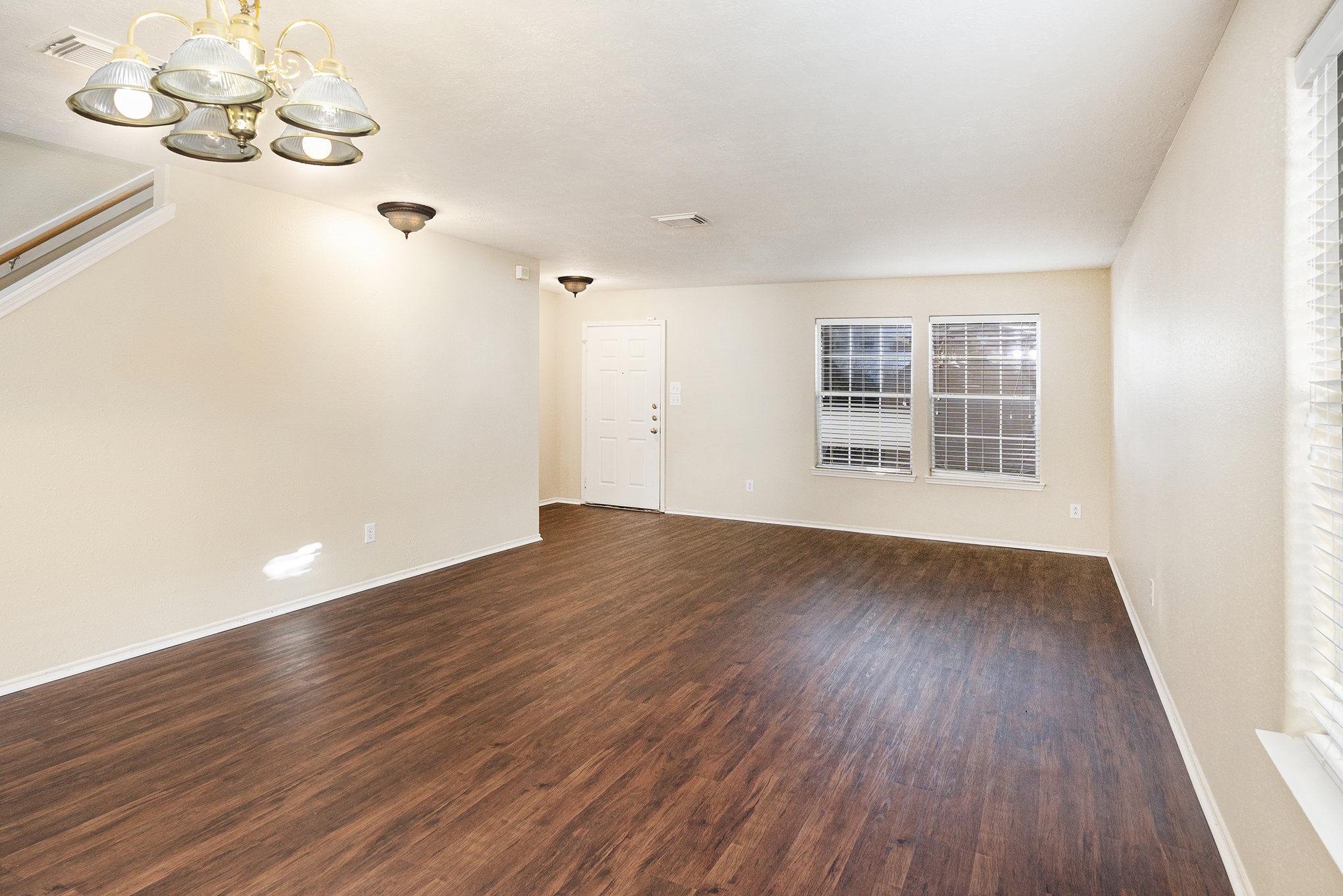 18227 Thicket Grove Road Houston, TX 77084 - Photo 5 of 28 an empty room with wooden floor and windows
