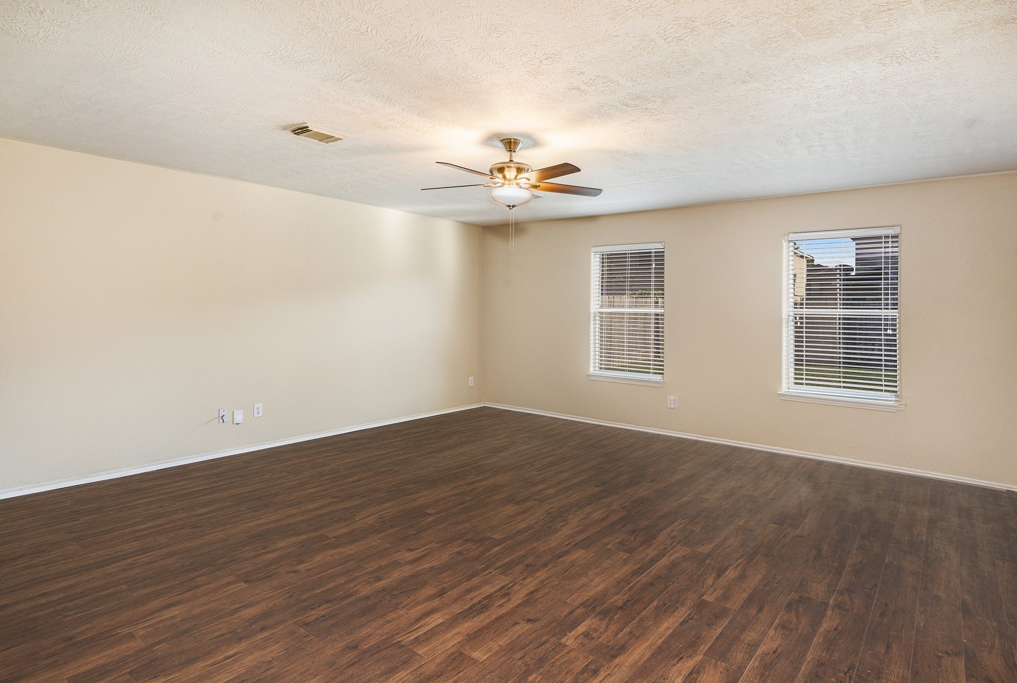 18227 Thicket Grove Road Houston, TX 77084 - Photo 6 of 28 a view of an empty room with wooden floor and a window