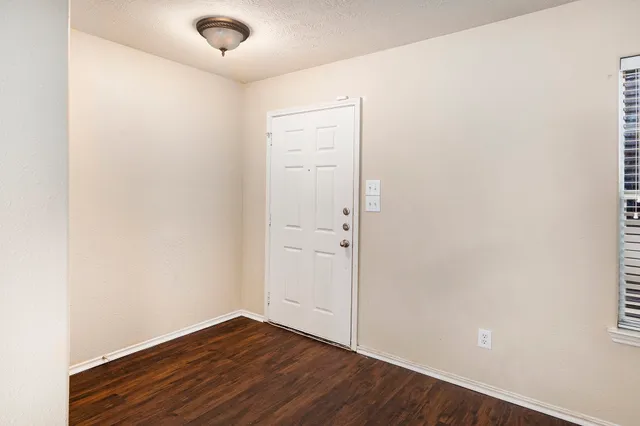 an empty room with wooden floor