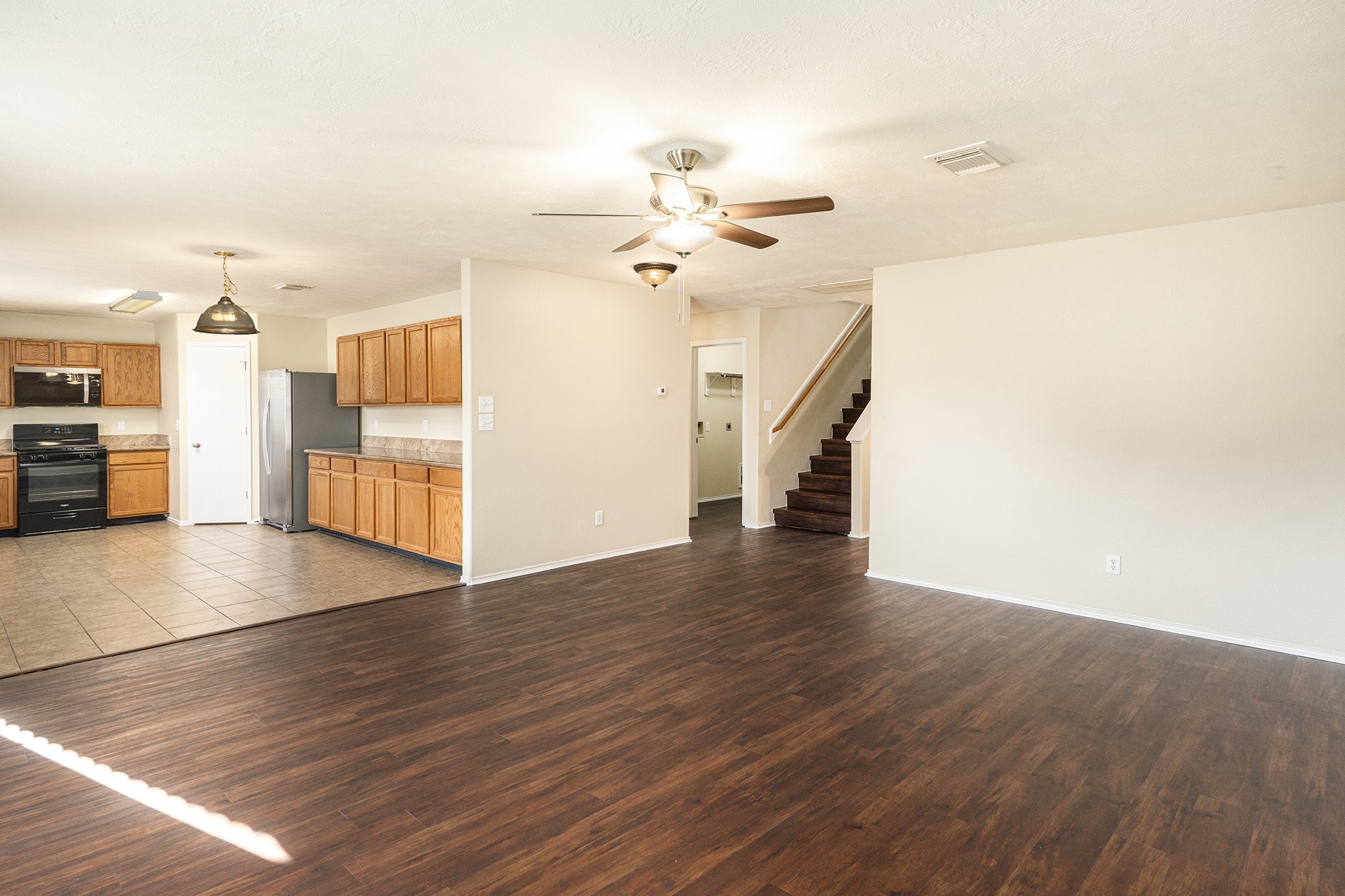 18227 Thicket Grove Road Houston, TX 77084 - Photo 9 of 28 a view of a livingroom with wooden floor and a ceiling fan