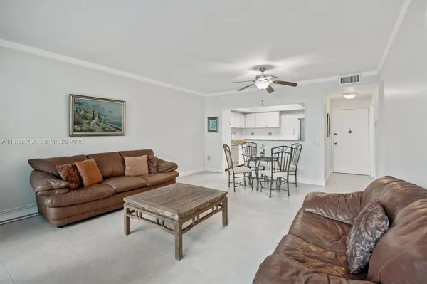 a living room with furniture a clock and a chandelier