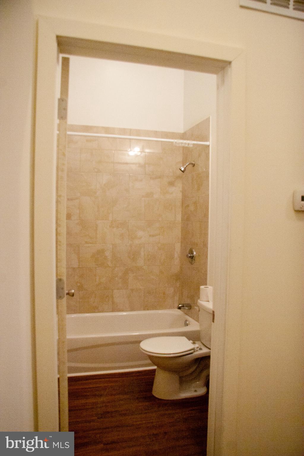 6040 Market Street, Unit 3 Philadelphia, PA 19139 - Photo 7 of 9 a bathroom with a sink a toilet and shower
