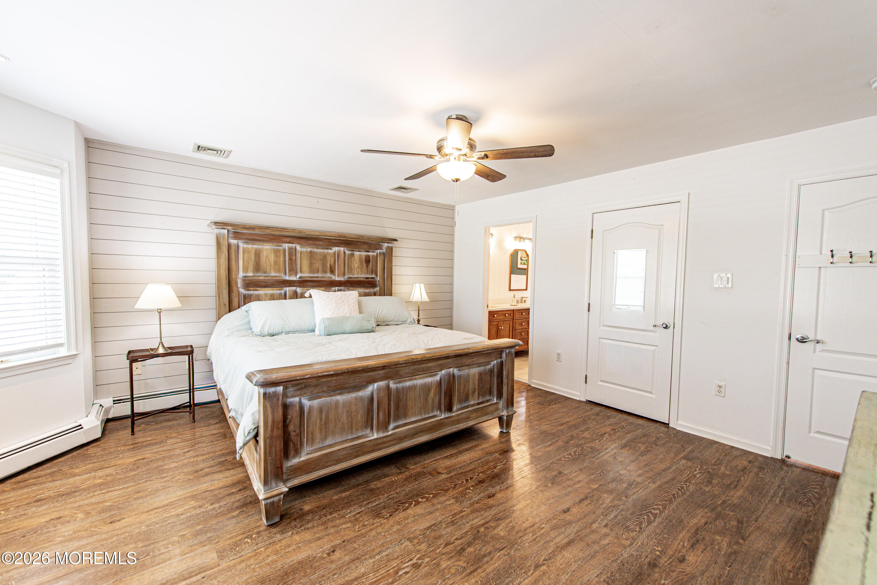 5 A Sunset Boulevard Barnegat Light, NJ 08006 - Photo 25 of 65 a bedroom with a bed and wooden floor