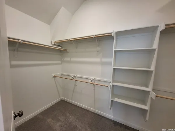 a view of a backyard with lawn chairs