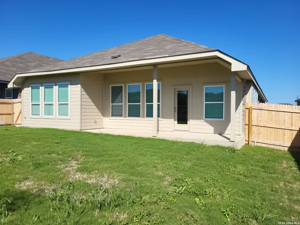 a view of a chairs and table in backyard
