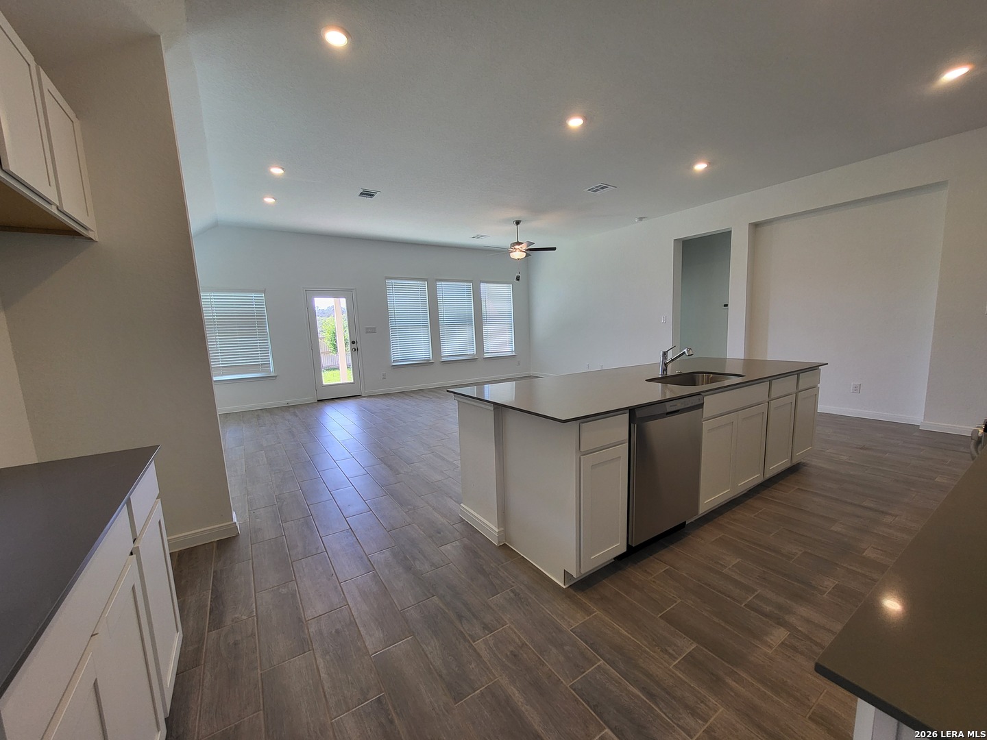 1233 Fox Wing Way New Braunfels, TX 78132 - Photo 5 of 19 a kitchen with stainless steel appliances granite countertop a sink and wooden floors
