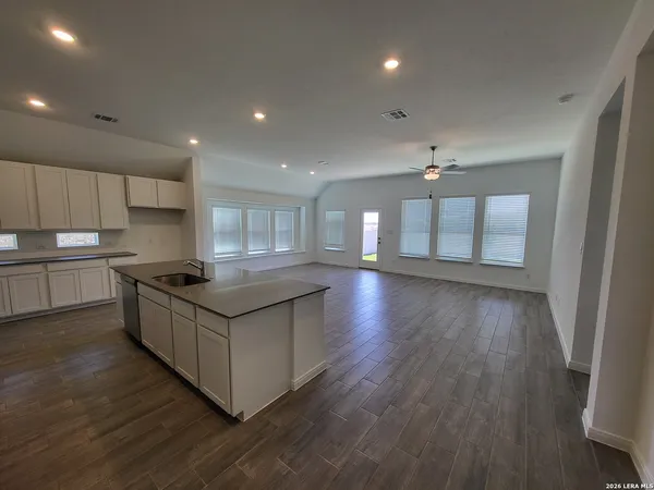 a kitchen with stainless steel appliances granite countertop a stove and a large window