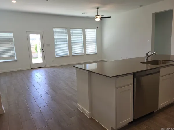 a kitchen with a sink cabinets and wooden floor