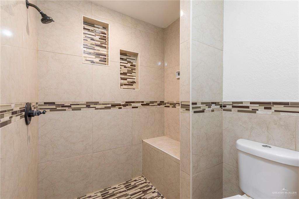 1312 North 5th Street McAllen, TX 78501 - Photo 11 of 25 The primary bathroom boasts a spacious, stand-alone shower for a luxurious feel.