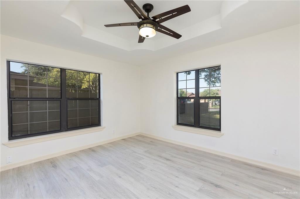 1312 North 5th Street McAllen, TX 78501 - Photo 16 of 25 The third bedroom is a nice size and filled with plenty of natural light. It offers a bright and comfortable space for any use. Located downstairs in the front of the home.