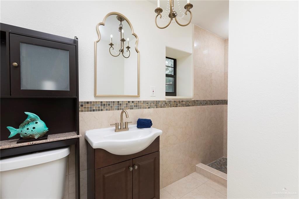 1312 North 5th Street McAllen, TX 78501 - Photo 17 of 25 The home features a second full bathroom with a stand-alone shower. It adds convenience and modern style for family and guests alike.