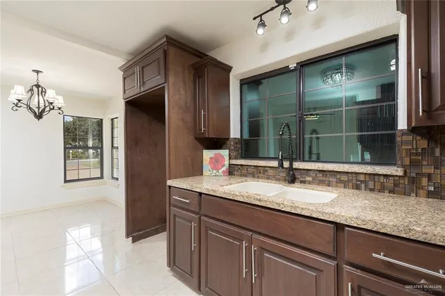 a kitchen with a sink stove and cabinets