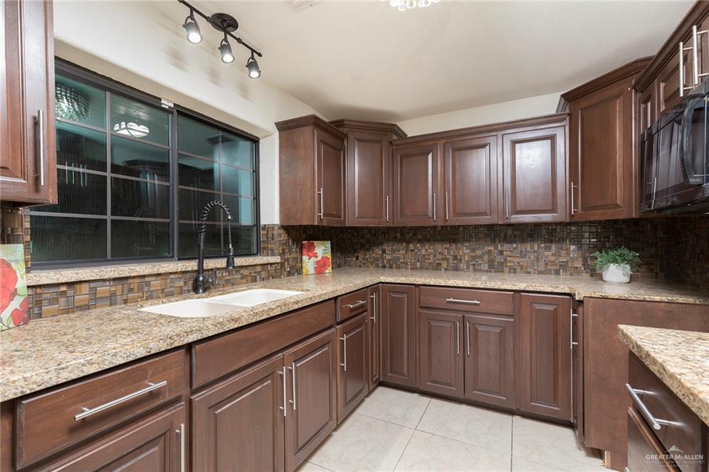 1312 North 5th Street McAllen, TX 78501 - Photo 6 of 25 Natural light fills the room, creating a warm and inviting atmosphere. Pretty lighting and so clean!