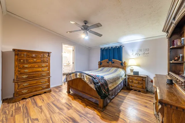 a bed room with a bed and a ceiling fan