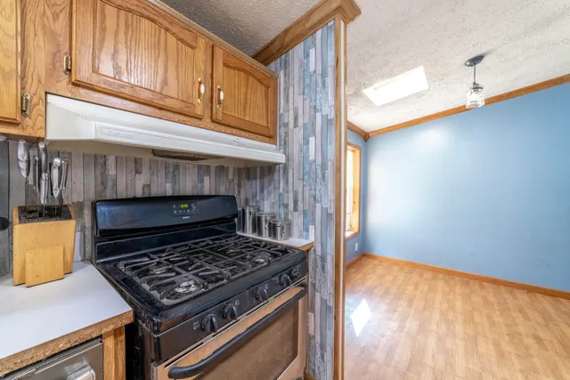 a stove top oven sitting inside of a kitchen
