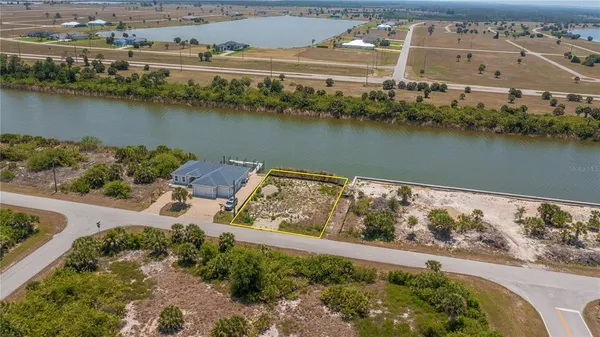 an aerial view of residential houses with outdoor space and lake view