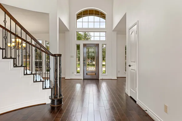 a view of an entryway with wooden floor windows and a livingroom