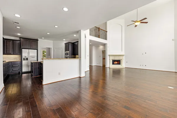 a view of a living room kitchen with furniture and wooden floor