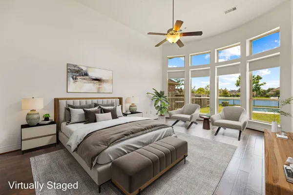 a bedroom with a bed and a large window