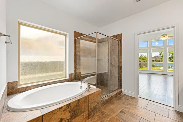 a bathroom with a tub and a shower