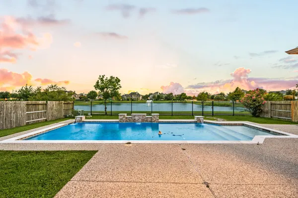 a view of a swimming pool with a yard