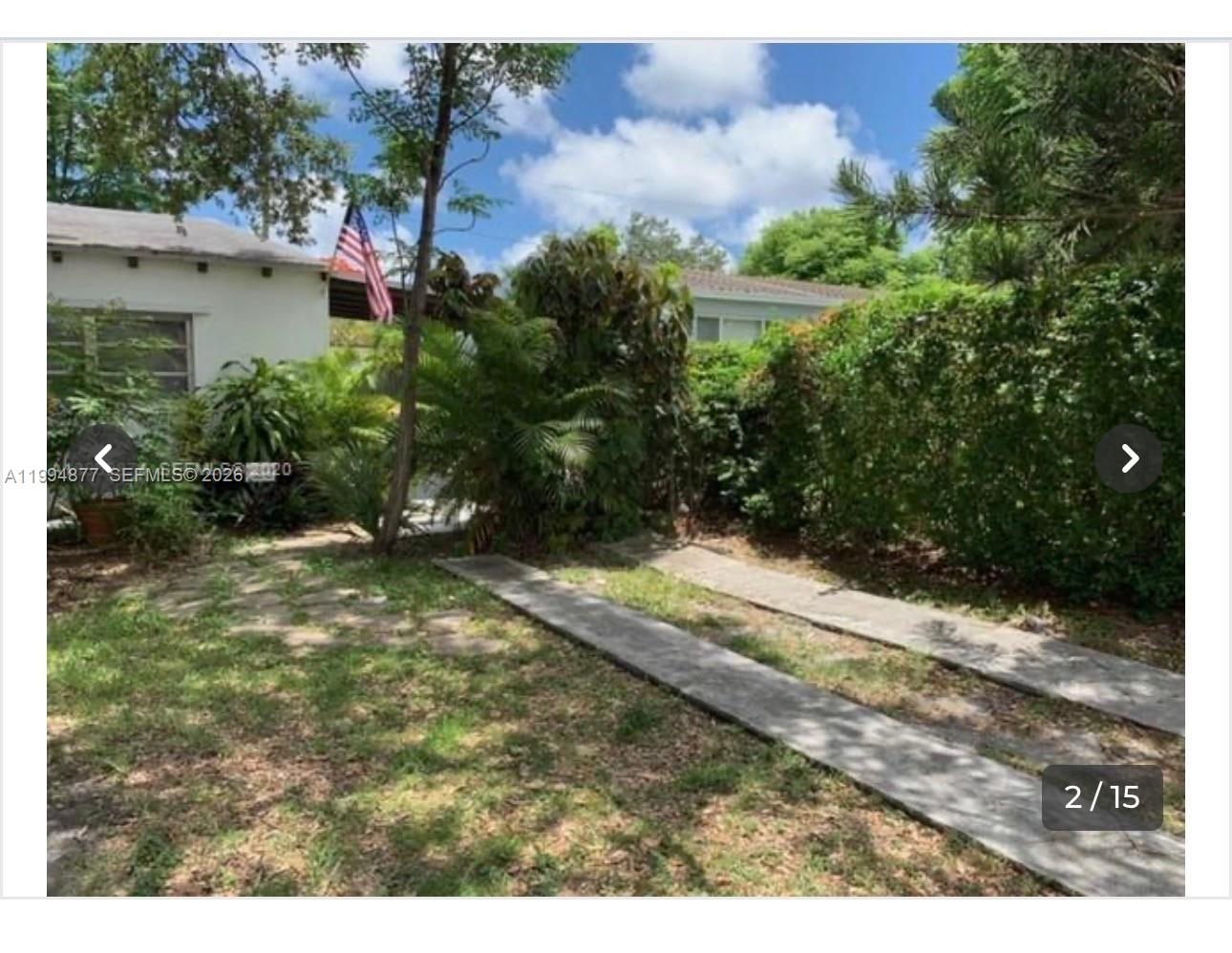 4230 Southwest 11th Street Miami, FL 33134 - Photo 2 of 8 a view of a yard with plants and a bench