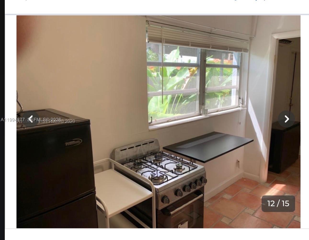 4230 Southwest 11th Street Miami, FL 33134 - Photo 6 of 8 a kitchen with a stove and a microwave