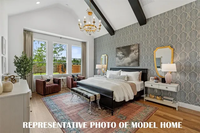 a bedroom with a bed a couch and potted plant on the dresser