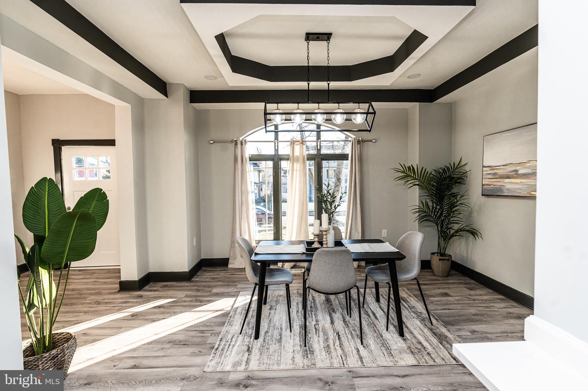 3910 Chatham Road Baltimore, MD 21207 - Photo 12 of 52 a view of a dining room with furniture window and wooden floor
