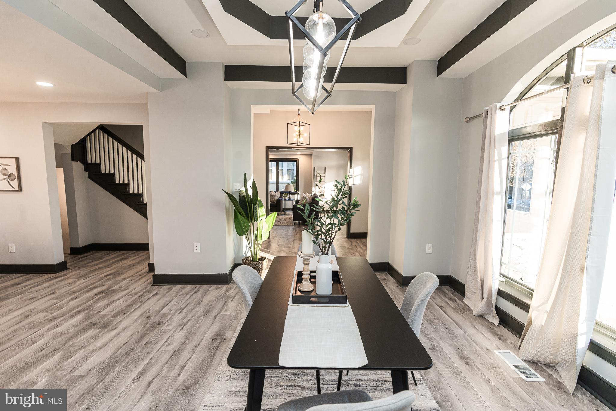 3910 Chatham Road Baltimore, MD 21207 - Photo 14 of 52 a living room with furniture and a chandelier