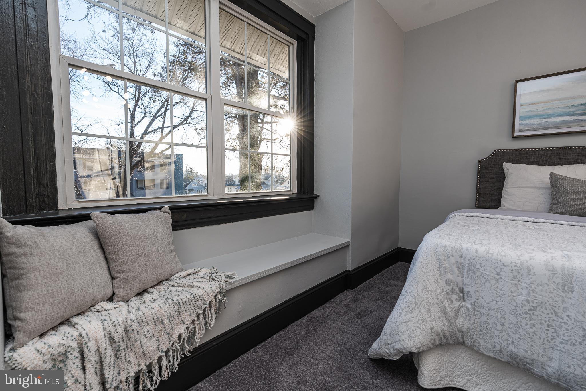 3910 Chatham Road Baltimore, MD 21207 - Photo 17 of 52 a bedroom with a bed lamp and window