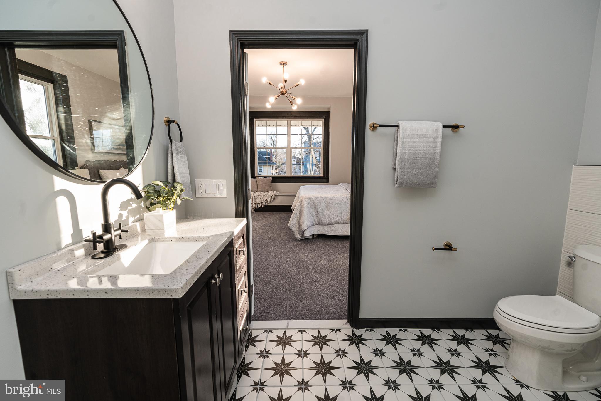 3910 Chatham Road Baltimore, MD 21207 - Photo 21 of 52 a bathroom with a sink toilet and mirror