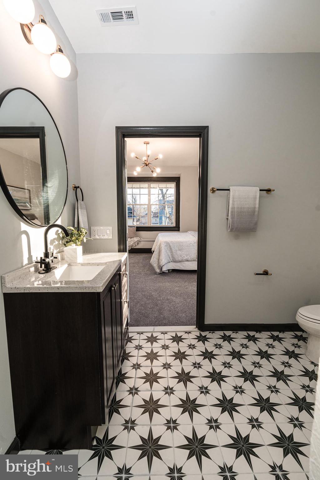 3910 Chatham Road Baltimore, MD 21207 - Photo 22 of 52 a bathroom with a sink a toilet and mirror