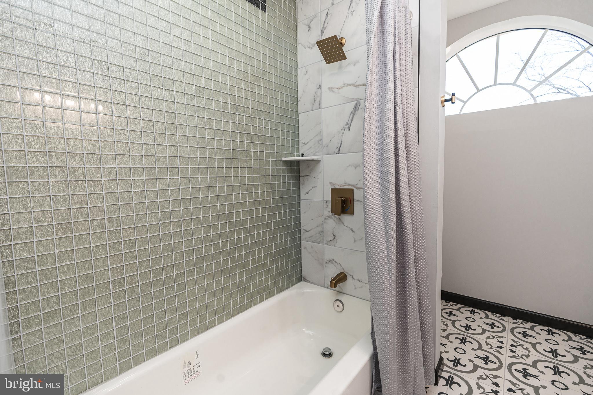 3910 Chatham Road Baltimore, MD 21207 - Photo 31 of 52 a bathroom with a bathtub and shower