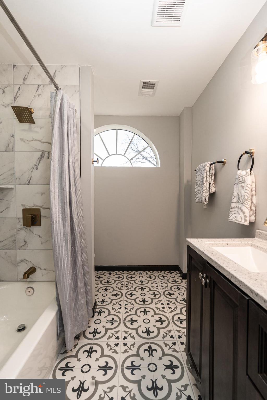 3910 Chatham Road Baltimore, MD 21207 - Photo 33 of 52 a bathroom with a bathtub sink and a shower