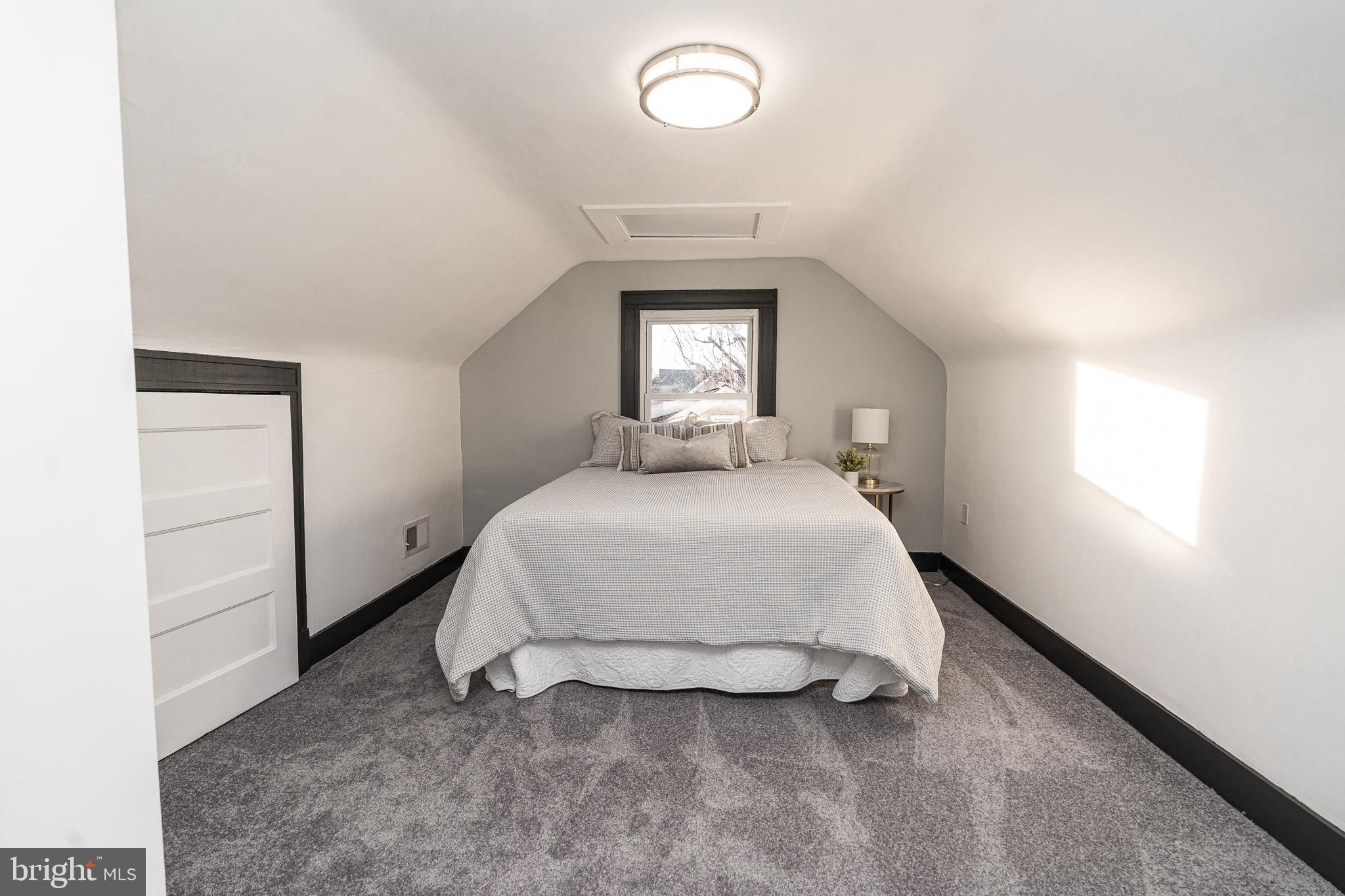 3910 Chatham Road Baltimore, MD 21207 - Photo 38 of 52 a bedroom with a bed and a window